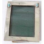 Edwardian Arts & Crafts silver photograph frame of rectangular form, set with two cabochon turquoise