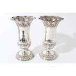 Pair of Edwardian silver spill vases, with embossed decoration scroll decoration and flared rims, ra