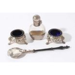 Pair of Victorian silver salts of cauldron form with embossed decoration, beaded border and blue gla