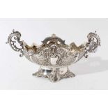 Edwardian silver table centre of oval form with embossed and pierced decoration with twin handles mo