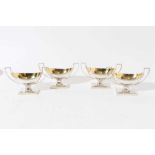 Set of four George III silver salts of navette form with reeded decoration, gilded interiors and twi