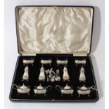 Extensive George V silver cruet set comprising four silver mustard pots of bulbous rectangular form