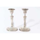 Pair of Victorian silver candlesticks with fluted tapering stems, urn-shaped candle holder with sepa