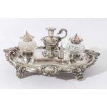 Victorian silver inkstand of oval form, with shell, scroll and leaf border, central chamberstick wit