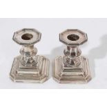 Pair of Edwardian dwarf candlesticks on stepped square bases with urn shaped candle holders, (Sheffi