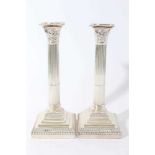 Pair of George V silver Corinthian column candlesticks (London 1914), maker Goldsmiths & Silversmith