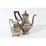 19th century white metal coffee pot of oval baluster form with engraved and chased decoration and an