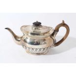 Victorian silver teapot of oval half reeded form with fruitwood knop and handle and engraved crest (