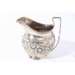 George III silver milk / cream jug of bellied form with chased floral, foliate and scroll decoration