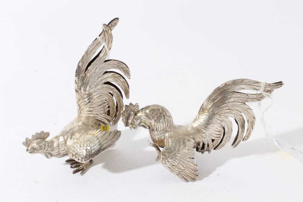Pair of silver models of fighting birds, London import hallmarks 1978, by Israel Freeman & Son Ltd