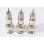 Trio of George V silver pepperettes in the Georgian style with engraved crests (London 1915), all at