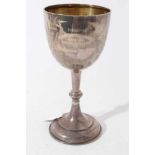 Edwardian silver trophy cup / goblet of conventional form with engraved foliate decoration and prese