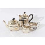 George V silver three piece teaset comprising teapot of cauldron form with faceted decoration, with