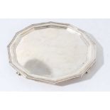 George V silver salver of octagonal form with reeded borders, raised on four feet, (Sheffield 1931),