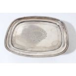 George III silver teapot stand of oval form with brite cut engraved decoration and central armorial,