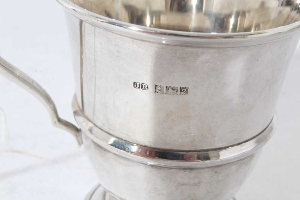 George V silver christening mug of tapered form with central reeded band, with scroll handle, on a c - Image 11 of 11