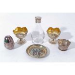 Pair of silver egg cups together with a silver egg, silver pin dish and other items