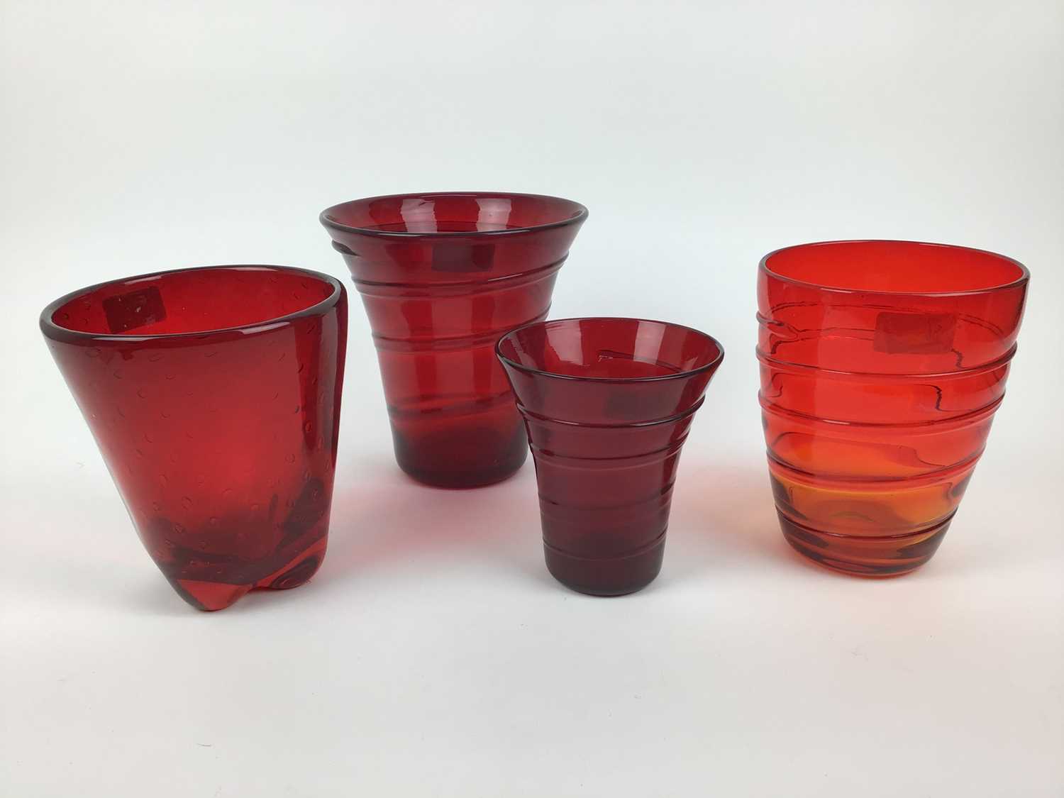 Three Whitefriars Ruby red ribbon trailed vases, 19cm, 18cm and 14cm