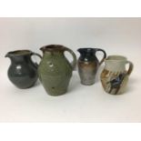 Four salt glazed studio pottery jugs by John Jelfs with green glaze, 19.5cm, Toff Milway with blue g