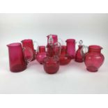 Selection of Victorian cranberry glass jugs and a decanter