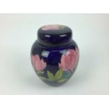 Moorcroft pottery ginger jar and cover decorated in the Magnolia pattern on blue ground, impressed m