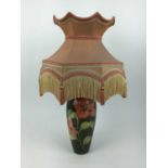 Moorcroft pottery table lamp decorated in the Hibiscus pattern on green ground, impressed marks to b