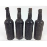 Port - four bottles, lacking labels but just visible are the seals of Corney & Barrow, the earliest