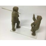 Inuit marine whalebone carving of a figure and polar bear, perspex base