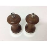 Pair of silver mounted pepper mills with turned waisted wooden bodies (London 1976), 10.5cm high