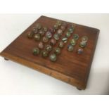 Victorian solitaire board and marbles.