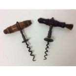 Two 19th century corkscrews with turned wooden handles, one with brush