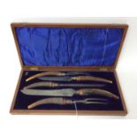 Edwardian five piece carving set with antler handles and silver ferrells, in original fitted case (S