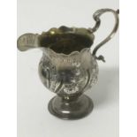 Early George III silver cream jug, maker AISN, London 1767, with fluted rim and embossed floral wryt
