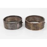 Two Victorian silver hinged bangles, one with applied and textured floral design, Birmingham 1883, t