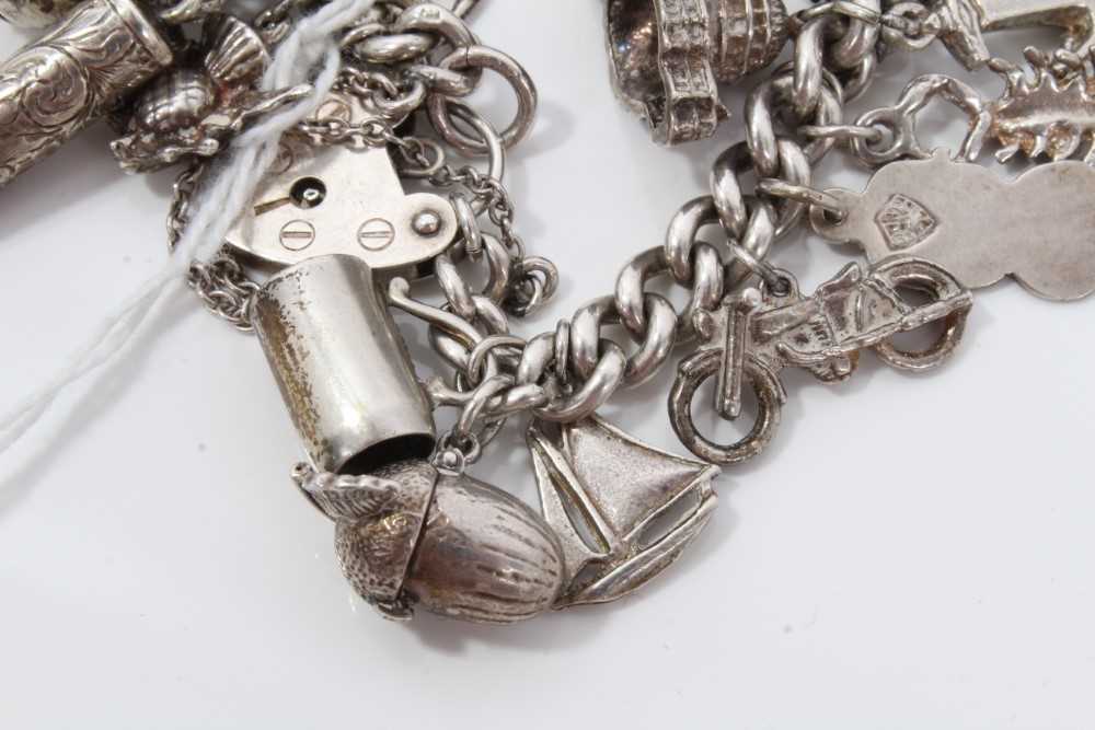 Silver charm bracelet with a collection of silver and white metal charm and padlock clasp. - Image 2 of 8