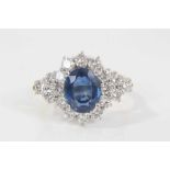 Sapphire and diamond cluster ring with an oval mixed cut blue sapphire measuring approximately 9.5mm