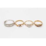 Four gold and gem-set rings to include a diamond two-stone cross-over ring (Birmingham 1913) size M,