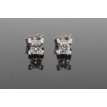 Pair of diamond single stone earrings, each with a princess cut diamond in 18ct white gold four claw