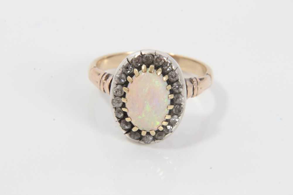 Antique opal and diamond cluster ring with an oval cabochon opal surrounded by nineteen old cut diam - Image 3 of 9