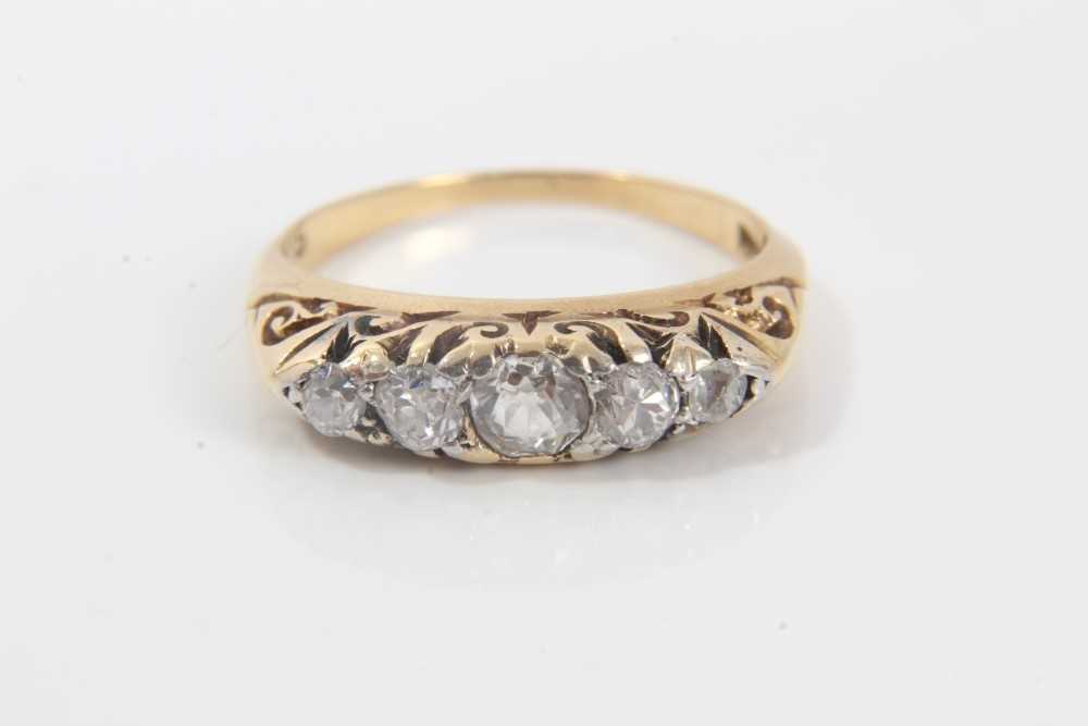 Late Victorian diamond five stone ring with five graduated old cut diamonds in carved gold claw sett