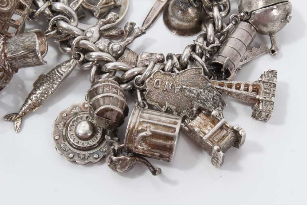 Silver charm bracelet with a collection of silver and white metal charm and padlock clasp. - Image 6 of 8