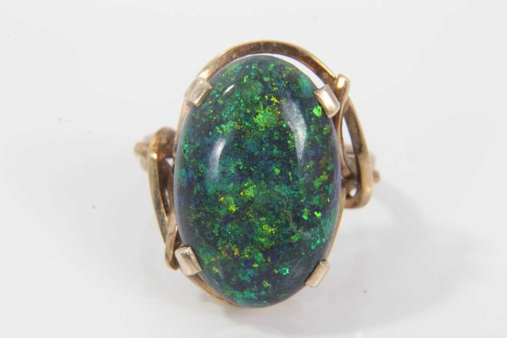 Black opal single stone ring with an oval black opal cabochon measuring approximately 20mm x 13mm x