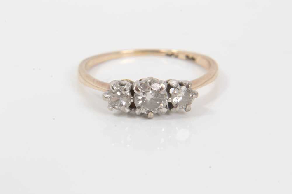 Diamond three stone ring with three round brilliant cut diamonds in claw setting on 18ct yellow gold