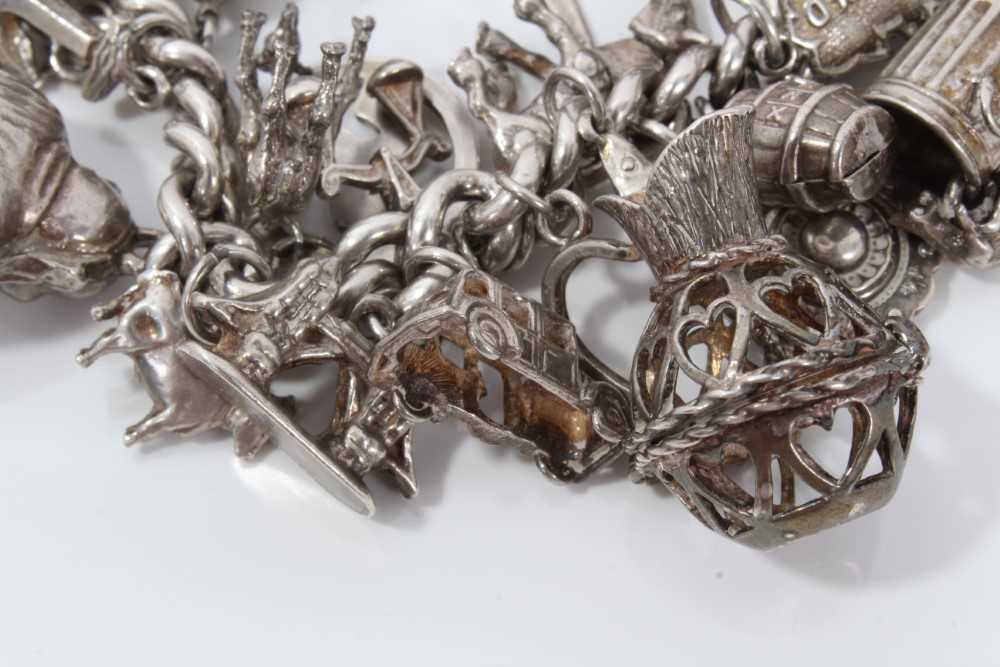 Silver charm bracelet with a collection of silver and white metal charm and padlock clasp. - Image 5 of 8