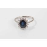 Sapphire and diamond cluster ring with an oval mixed cut blue sapphire measuring approximately, surr