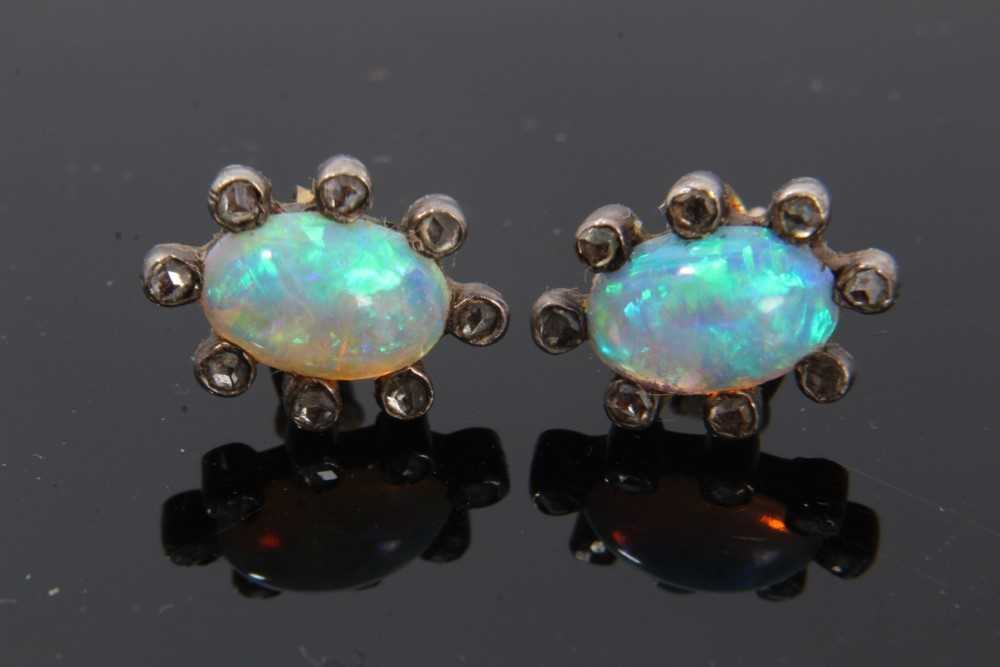 Pair of antique opal and diamond earrings, each with a opal cabochon surrounded by rose cut diamonds