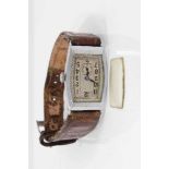 Art Deco mid-size wristwatch with tonneau shape dial in chromium plated case on leather strap