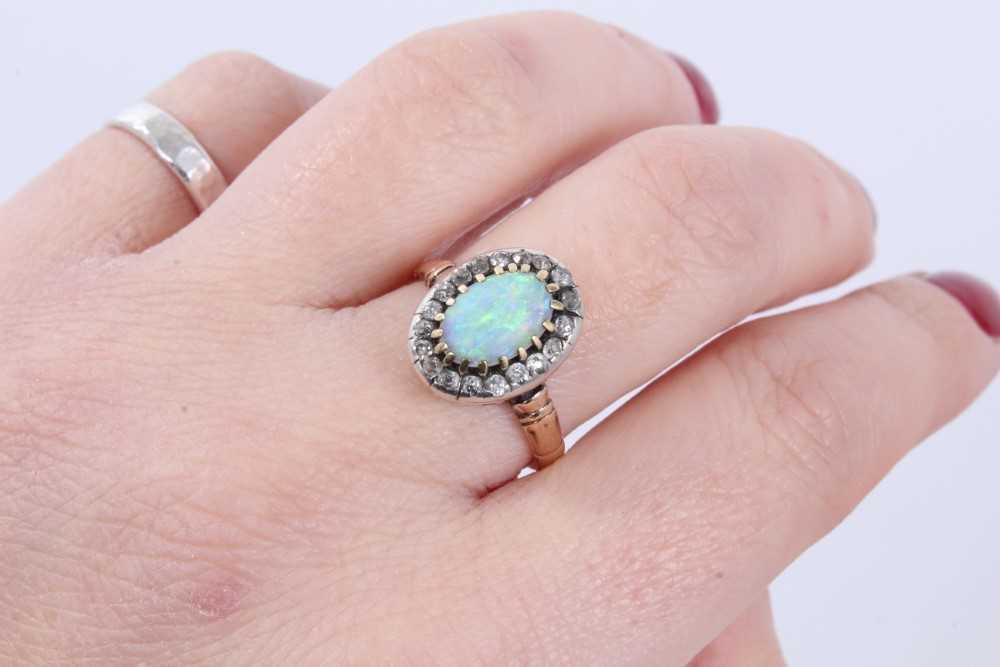 Antique opal and diamond cluster ring with an oval cabochon opal surrounded by nineteen old cut diam - Image 8 of 9