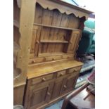 Pine two height dresser with three cupboard doors and draws below