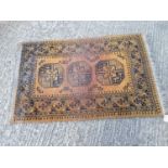 Eastern rug with geometric decoration on gold and black ground, 138cm x 91cm